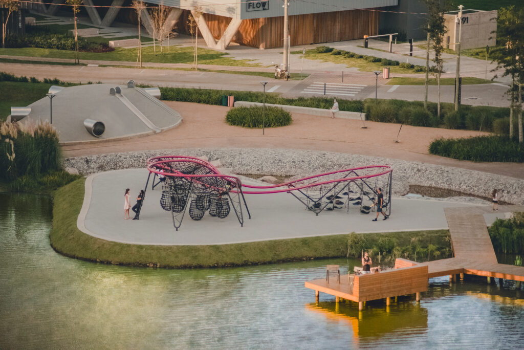 large linear play structure with hammocks, netting, and pods.