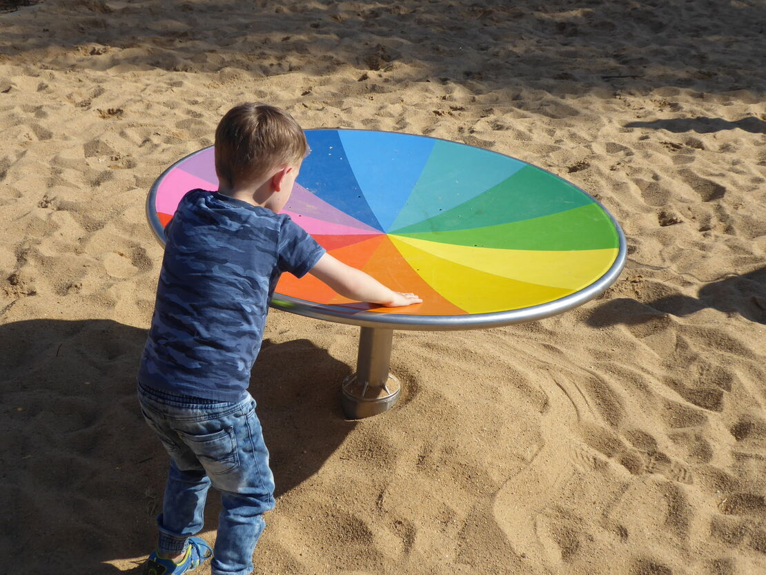 Child playing with color mixer dish